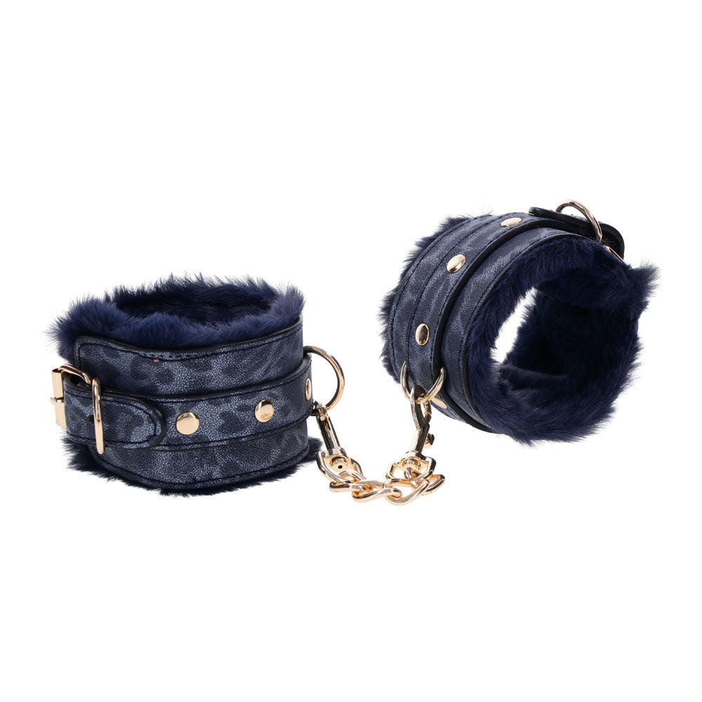 Navy blue faux fur handcuffs with gold chain and buckles for luxurious bondage play, side view | Flirty Bay online adult store, adult toys and lingerie